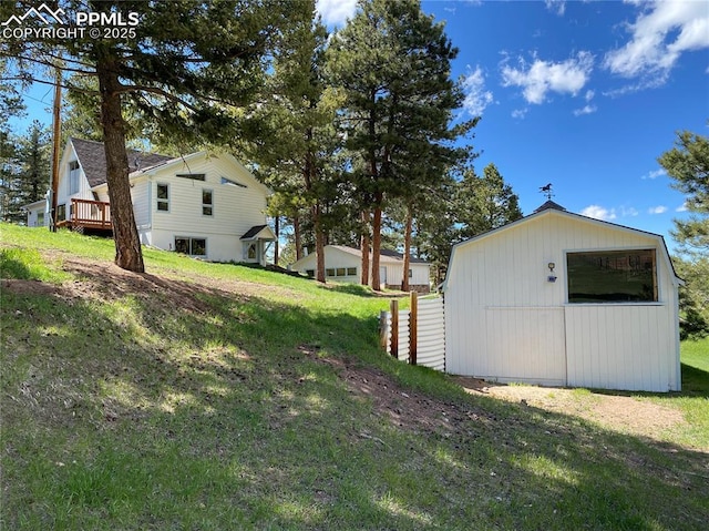 845 Markus Rd, Woodland Park, CO 80863 - view of green lawn with an outbuilding and a wooden deck