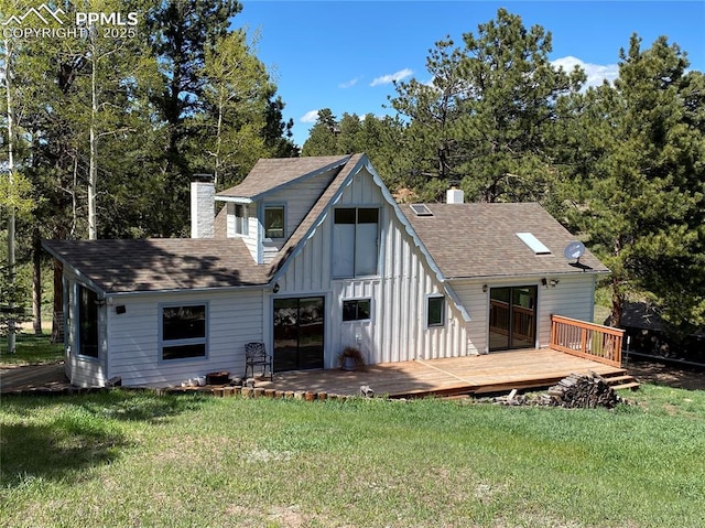845 Markus Rd, Woodland Park, CO 80863 - rear view of house featuring a chimney, board and batten siding, a deck, and a lawn