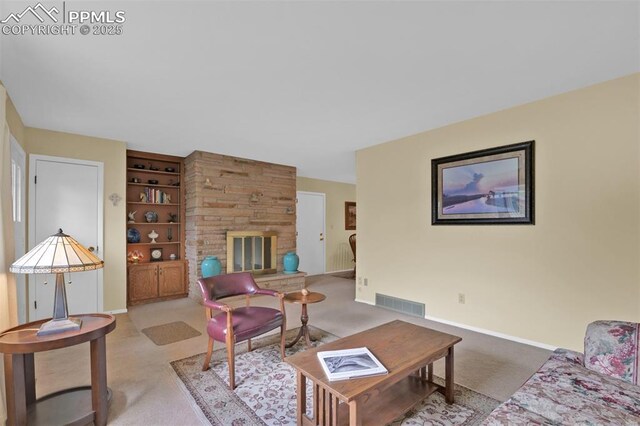 751 Crown Ridge Dr, Colorado Springs, CO 80904 - carpeted living area featuring built in shelves, baseboards, and a fireplace