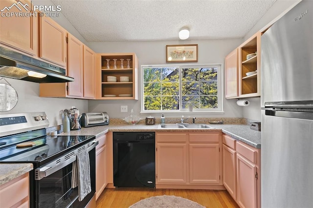 3870 Chinawood Ct, Colorado Springs, CO 80918 - kitchen featuring stainless steel appliances, under cabinet range hood, open shelves, a sink, and light wood-type flooring