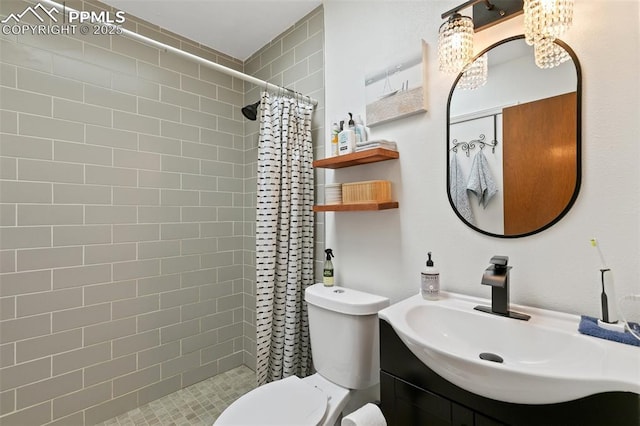 3870 Chinawood Ct, Colorado Springs, CO 80918 - bathroom with toilet, vanity, a tile shower, and a chandelier