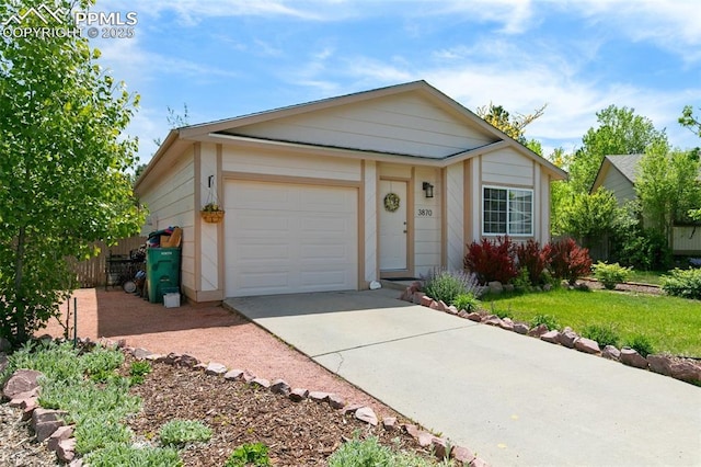 3870 Chinawood Ct, Colorado Springs, CO 80918 - ranch-style house featuring driveway, a garage, and a front lawn