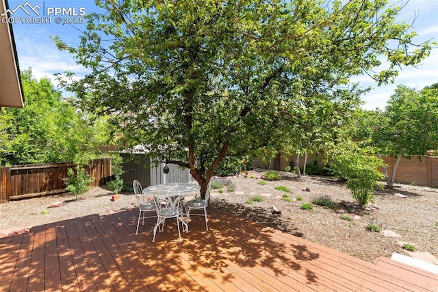 3870 Chinawood Ct, Colorado Springs, CO 80918 - deck with a fenced backyard and outdoor dining area