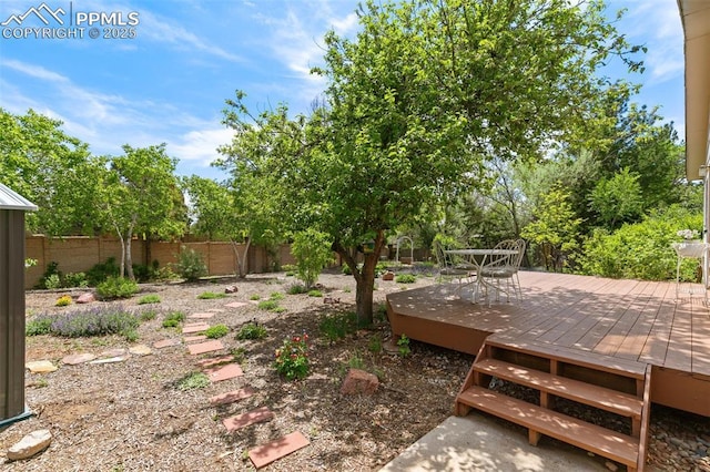 3870 Chinawood Ct, Colorado Springs, CO 80918 - fenced backyard featuring a deck and outdoor dining area
