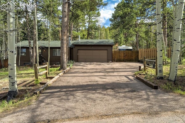 1015 Lafayette Ave, Woodland Park, CO 80863 - view of front of property featuring asphalt driveway, an attached garage, and roof with shingles