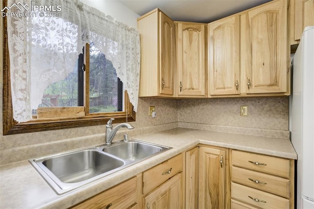 1015 Lafayette Ave, Woodland Park, CO 80863 - kitchen featuring light brown cabinetry, freestanding refrigerator, a sink, and light countertops