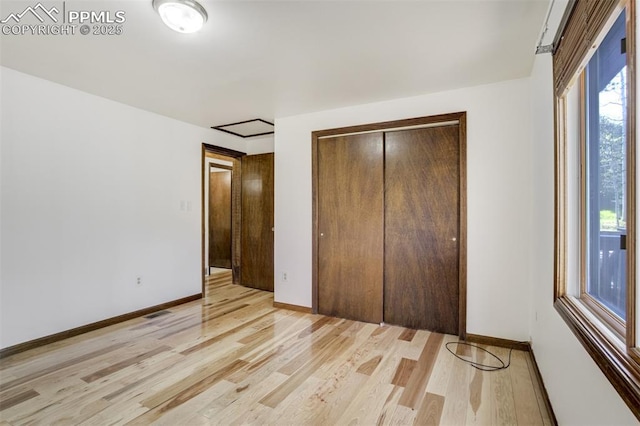1015 Lafayette Ave, Woodland Park, CO 80863 - unfurnished bedroom with light wood-style floors, a closet, and baseboards