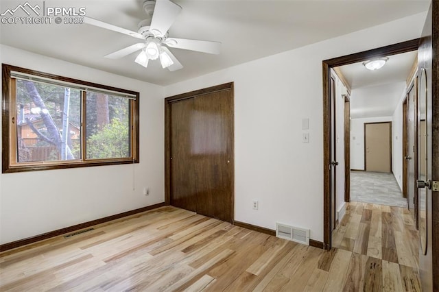 1015 Lafayette Ave, Woodland Park, CO 80863 - unfurnished bedroom with light wood finished floors, a closet, baseboards, and a ceiling fan