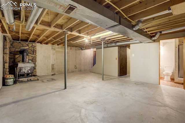 1015 Lafayette Ave, Woodland Park, CO 80863 - unfinished basement with a wood stove