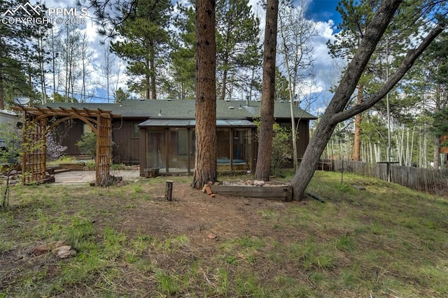 1015 Lafayette Ave, Woodland Park, CO 80863 - back of house with a sunroom and a pergola