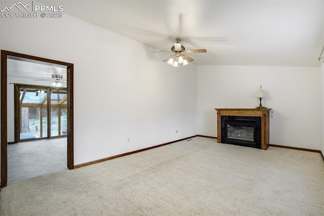 1015 Lafayette Ave, Woodland Park, CO 80863 - unfurnished living room with a ceiling fan, carpet floors, a tile fireplace, and baseboards