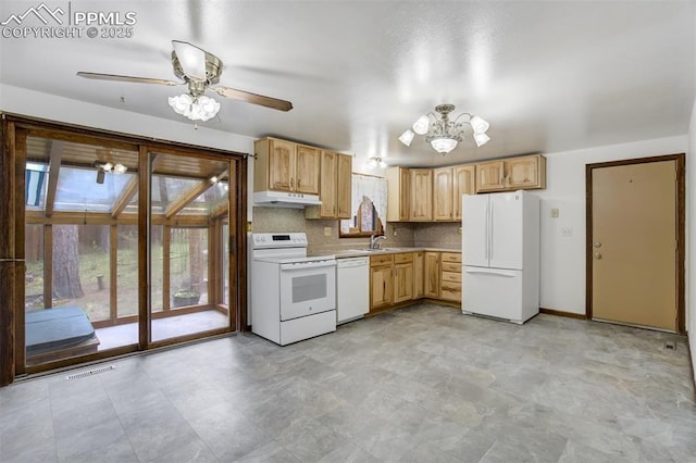 1015 Lafayette Ave, Woodland Park, CO 80863 - kitchen with white appliances, under cabinet range hood, a sink, a chandelier, and light countertops