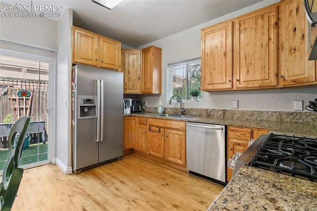 1502 York Rd Unit 103, Colorado Springs, CO 80918 - kitchen featuring stainless steel appliances, a sink, light wood finished floors, and light stone counters