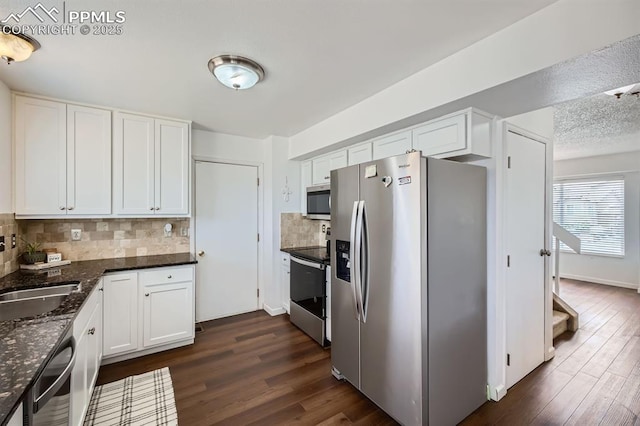 1155 Hallamwood Dr, Colorado Springs, CO 80911 - kitchen featuring stainless steel appliances, dark wood finished floors, and white cabinetry