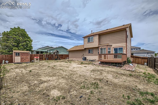 1155 Hallamwood Dr, Colorado Springs, CO 80911 - rear view of house with a wooden deck, a fenced backyard, and central AC