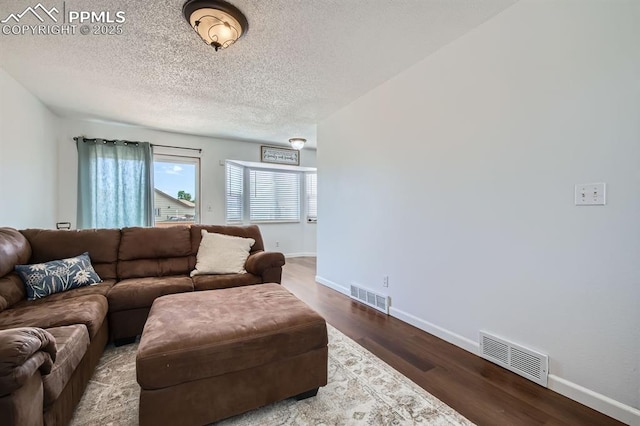 1155 Hallamwood Dr, Colorado Springs, CO 80911 - living area with wood finished floors, baseboards, and a textured ceiling