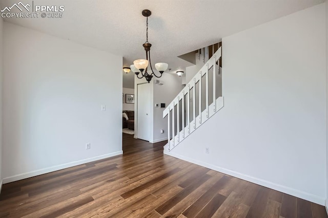 1155 Hallamwood Dr, Colorado Springs, CO 80911 - empty room featuring a chandelier, stairway, wood finished floors, and baseboards