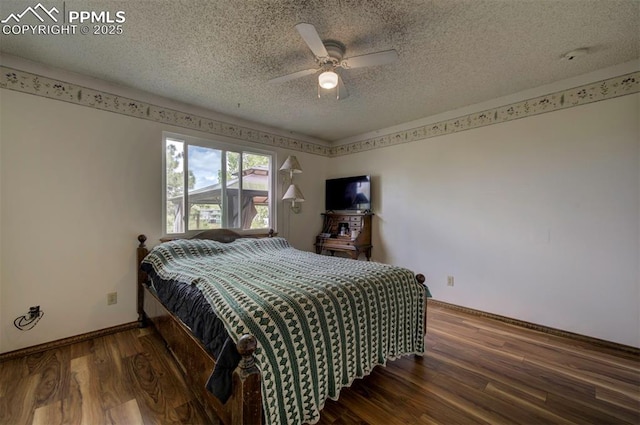 6938 Big Timber Dr, Colorado Springs, CO 80923 - bedroom featuring baseboards, wood finished floors, a textured ceiling, and a ceiling fan