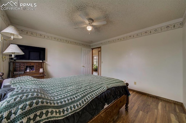 6938 Big Timber Dr, Colorado Springs, CO 80923 - bedroom with a textured ceiling, wood finished floors, baseboards, and a ceiling fan