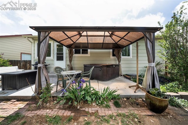 6938 Big Timber Dr, Colorado Springs, CO 80923 - back of house with a hot tub, a gazebo, and a patio
