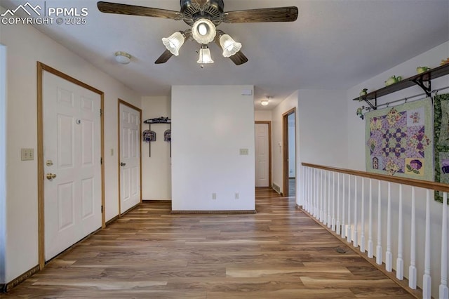6938 Big Timber Dr, Colorado Springs, CO 80923 - spare room featuring a ceiling fan, wood finished floors, and baseboards