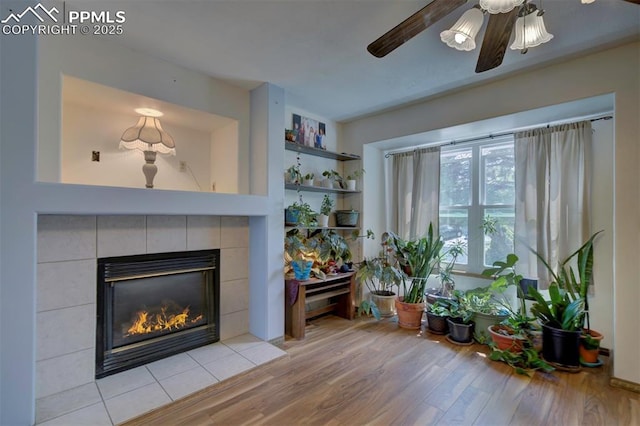 6938 Big Timber Dr, Colorado Springs, CO 80923 - living area with wood finished floors, a fireplace, and a ceiling fan