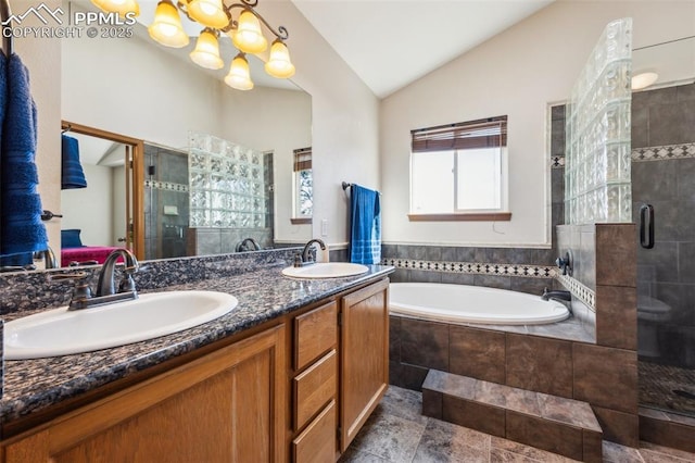 14810 Tanner Trl, Elbert, CO 80106 - bathroom featuring lofted ceiling, a shower stall, a bath, double vanity, and a chandelier