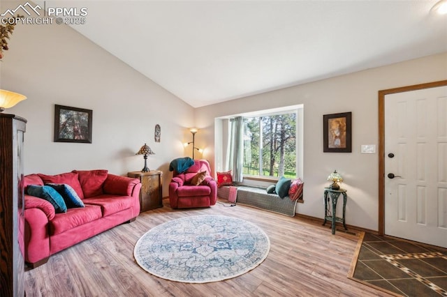 14810 Tanner Trl, Elbert, CO 80106 - living room featuring vaulted ceiling, baseboards, and wood finished floors