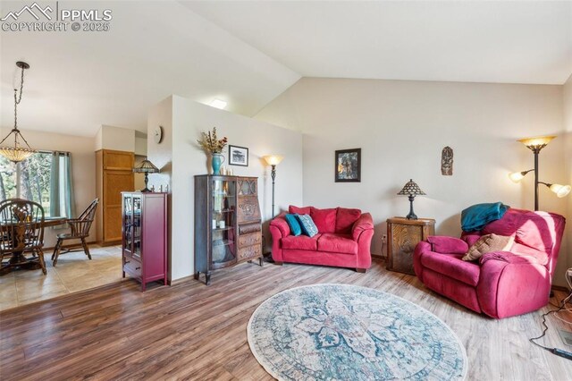 14810 Tanner Trl, Elbert, CO 80106 - living room with vaulted ceiling and wood finished floors
