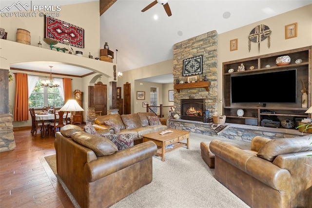 11720 Smokey Hill Grv, Colorado Springs, CO 80908 - living area featuring a chandelier, a ceiling fan, arched walkways, a fireplace, and high vaulted ceiling