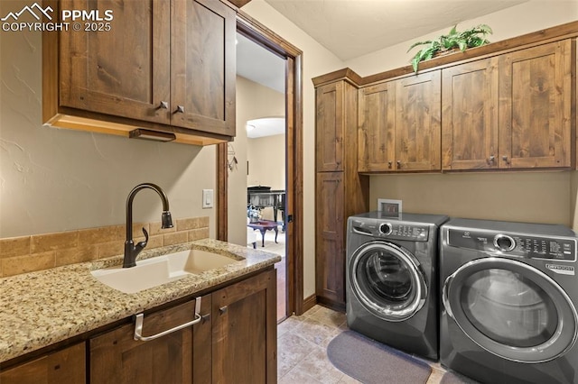 11720 Smokey Hill Grv, Colorado Springs, CO 80908 - laundry area with cabinet space, washer and dryer, and light tile patterned floors