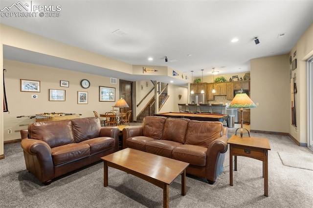 11720 Smokey Hill Grv, Colorado Springs, CO 80908 - living room featuring light colored carpet, stairway, bar area, and recessed lighting