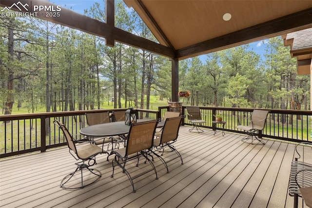 11720 Smokey Hill Grv, Colorado Springs, CO 80908 - deck featuring outdoor dining space and view of wooded area