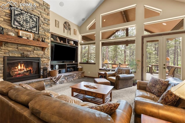 11720 Smokey Hill Grv, Colorado Springs, CO 80908 - carpeted living room with healthy amount of natural light, a stone fireplace, french doors, and high vaulted ceiling