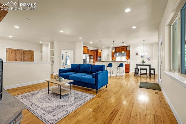 4775 Neeper Valley Rd, Manitou Springs, CO 80829 - living room featuring light wood-style flooring, recessed lighting, baseboards, and a chandelier