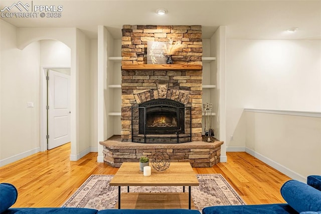 4775 Neeper Valley Rd, Manitou Springs, CO 80829 - living area featuring a stone fireplace, wood finished floors, and baseboards