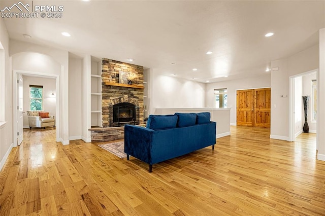 4775 Neeper Valley Rd, Manitou Springs, CO 80829 - living area featuring light wood-type flooring, a fireplace, recessed lighting, and healthy amount of natural light