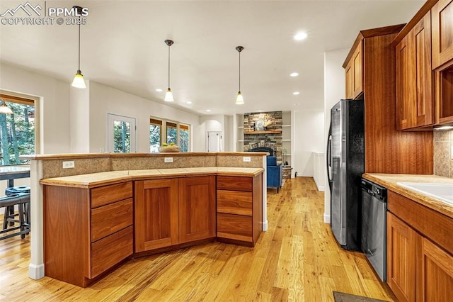 4775 Neeper Valley Rd, Manitou Springs, CO 80829 - kitchen featuring dishwasher, freestanding refrigerator, brown cabinets, light wood finished floors, and recessed lighting