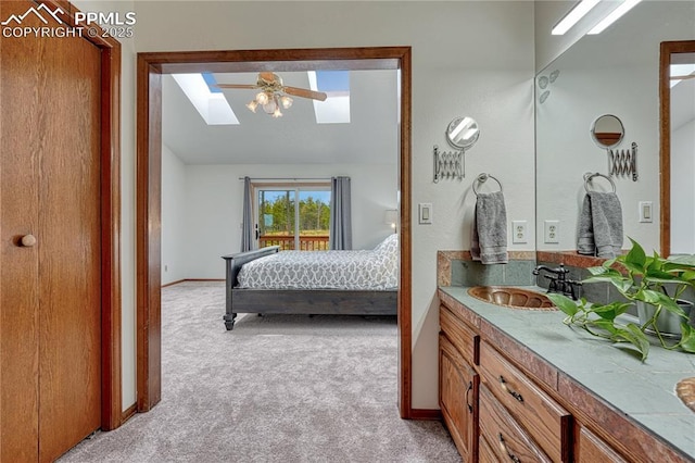 12475 Hereford Way, Colorado Springs, CO 80908 - ensuite bathroom with a skylight, vanity, baseboards, and vaulted ceiling