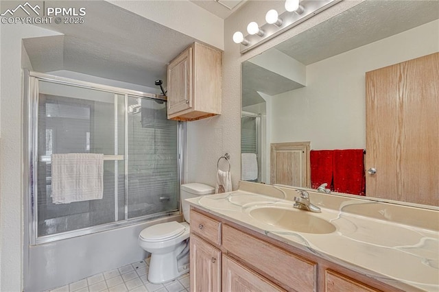 12475 Hereford Way, Colorado Springs, CO 80908 - full bathroom featuring toilet, vanity, tile patterned flooring, shower / bath combination with glass door, and a textured ceiling