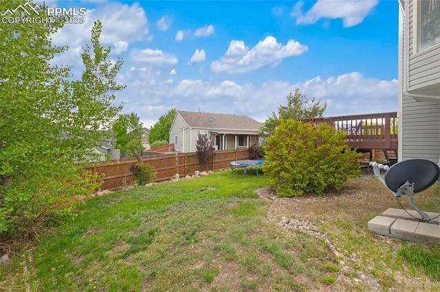 6755 Akerman Dr, Colorado Springs, CO 80923 - view of yard with a trampoline and a wooden deck