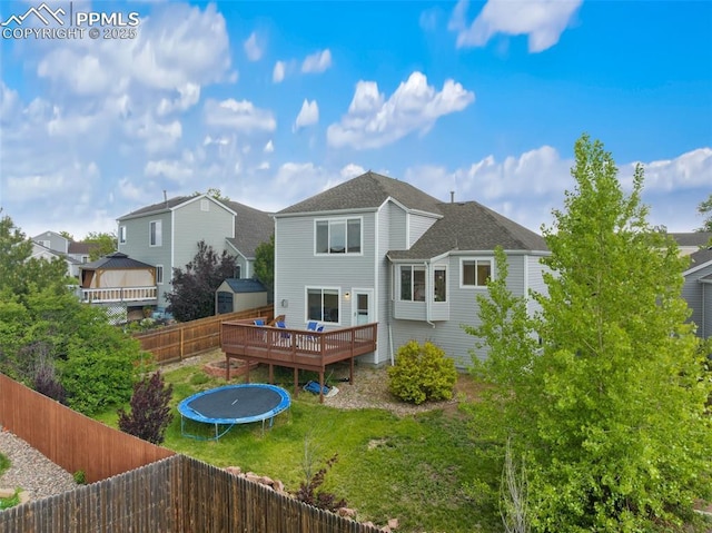 6755 Akerman Dr, Colorado Springs, CO 80923 - back of house featuring a wooden deck and a trampoline