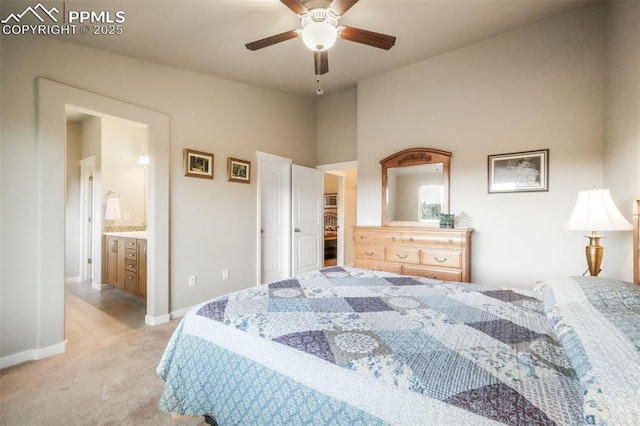 6015 Trappers Tale Ct, Colorado Springs, CO 80923 - bedroom featuring light colored carpet, baseboards, connected bathroom, and ceiling fan