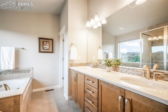 6015 Trappers Tale Ct, Colorado Springs, CO 80923 - bathroom with double vanity, a bath, tile patterned flooring, and baseboards