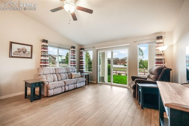 6015 Trappers Tale Ct, Colorado Springs, CO 80923 - living area featuring lofted ceiling, light wood-style flooring, healthy amount of natural light, a ceiling fan, and baseboards