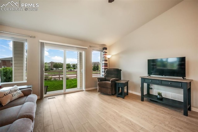 6015 Trappers Tale Ct, Colorado Springs, CO 80923 - living area featuring wood finished floors, lofted ceiling, and baseboards