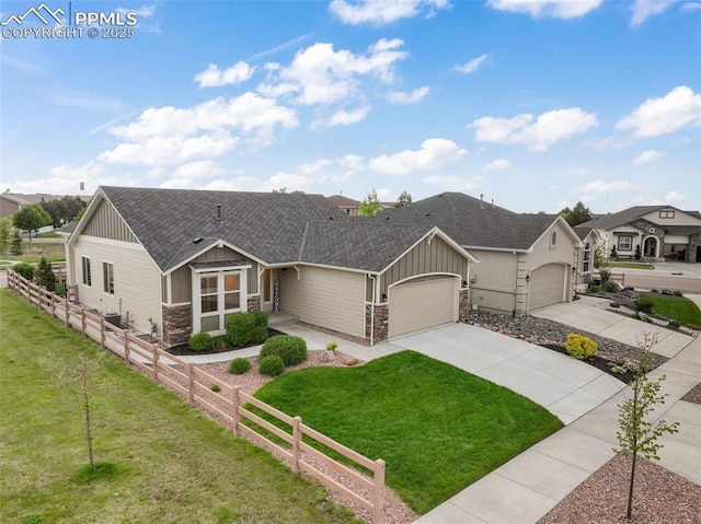 6015 Trappers Tale Ct, Colorado Springs, CO 80923 - view of front of house with a shingled roof, stone siding, an attached garage, board and batten siding, and concrete driveway