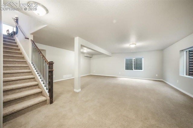6015 Trappers Tale Ct, Colorado Springs, CO 80923 - below grade area with carpet, stairway, and baseboards