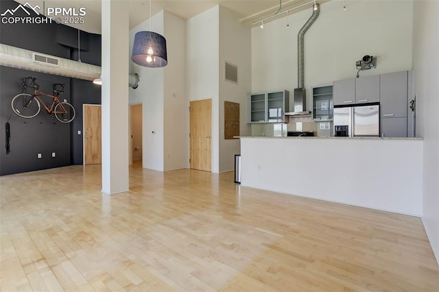 3100 Huron St Unit 4N, Denver, CO 80202 - unfurnished living room with a towering ceiling and light wood finished floors