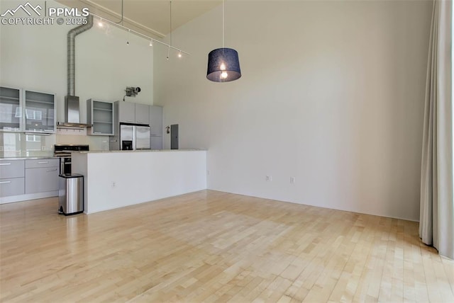 3100 Huron St Unit 4N, Denver, CO 80202 - unfurnished living room with a towering ceiling, light wood finished floors, and attic access